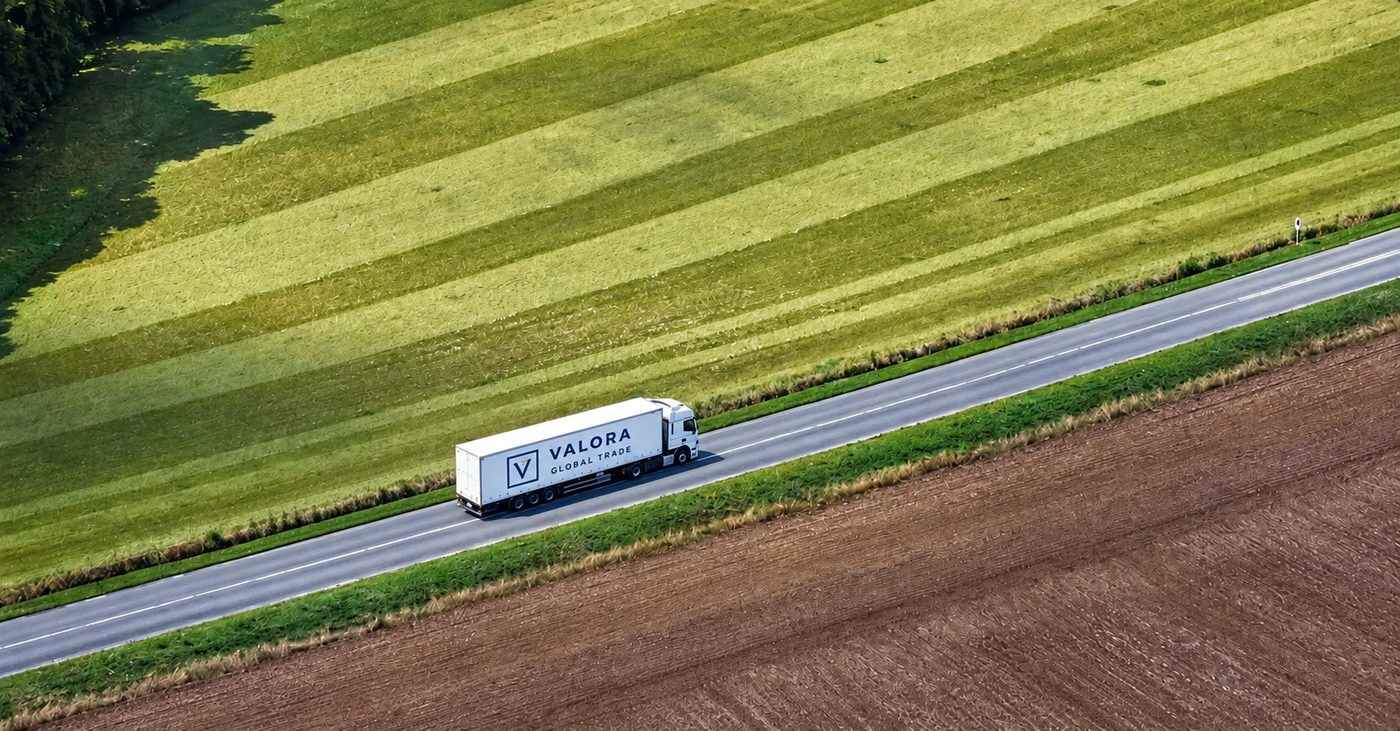 A EnValora Group truck driving on a road through green farmland